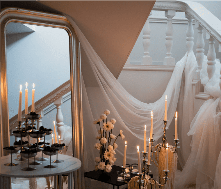 Elegant staircase with candles and flowers.