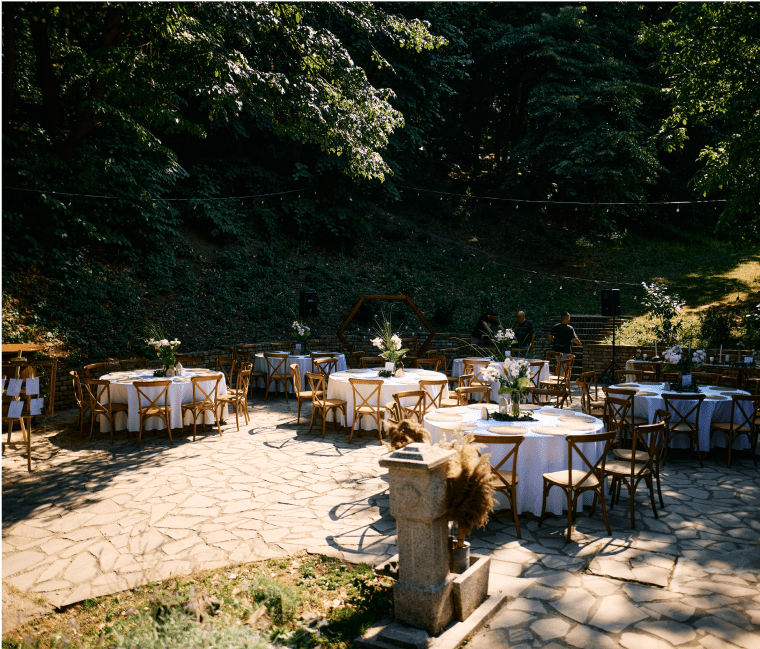 Outdoor wedding reception setup with decorated tables.